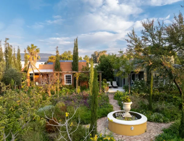 Aerial view over the garden and cottages at 81 On Church, with the Swartberg beyond