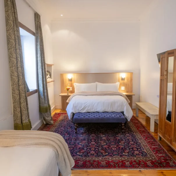 The Front Room at 81 On Church, showing the bed and bench