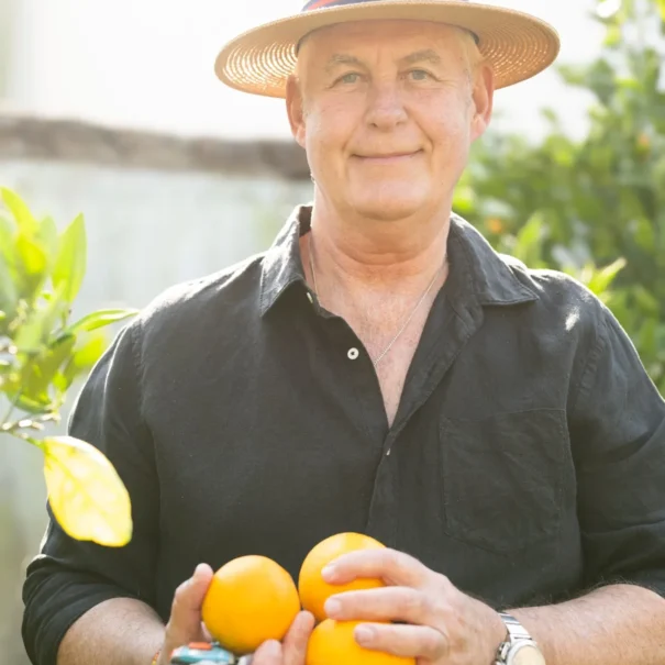 Johan Lubbe, owner of 81 On Church, wearing a straw hat in the garden