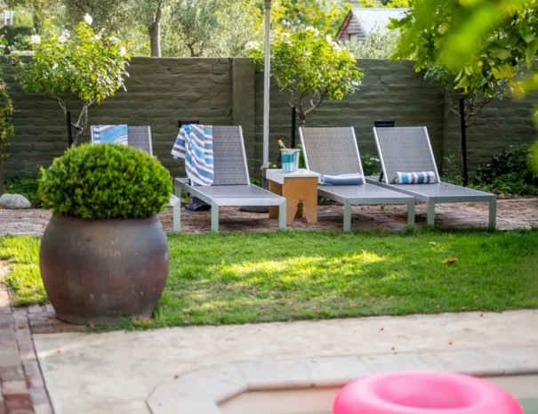 Poolside loungers under the trees at 81 On Church