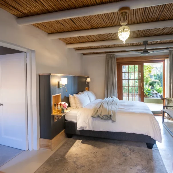 The Pool Room at 81 On Church, with a reed ceiling and doors to the garden