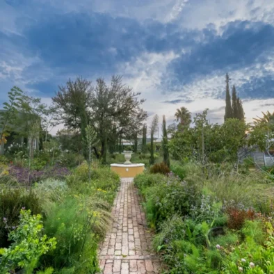 A wide view of the garden and sundial against the sky at 81 On Church